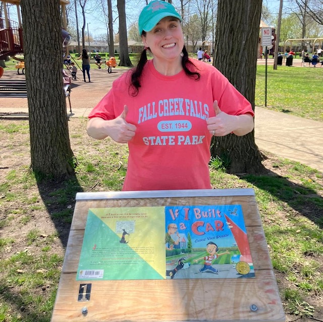 Library staff member with a StoryWalk podium
